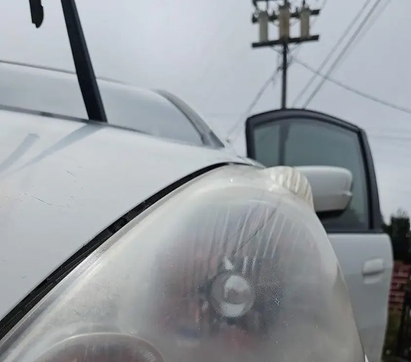 Close-up of a restored, clear vehicle headlight after detailing by Fast Clean Mobile Detailing.