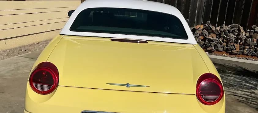 Rear view of a yellow convertible after a Fast Clean Mobile Detailing exterior detail.